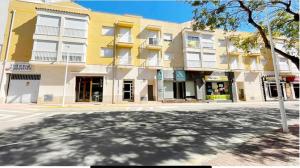 an empty street in front of a building at Apartamento en el Edificio Barlovento, situado en el centro de Alcossebre, a 150m del mar in Alcossebre