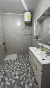 a white bathroom with a sink and a mirror at kaizen Restaurant Nouakchott in Nouakchott