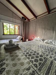 a bedroom with a bed with a quilt on it at Hospedaje Los Angeles in Futaleufú