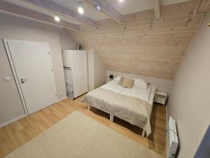 a bedroom with a bed in a room with wooden ceilings at Osada Kukówko in Wdzydze Tucholskie