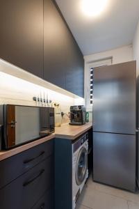 una cucina con frigorifero e lavatrice di DevIn Coworking & Coliving a Devin