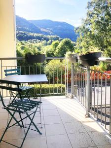 d'une table et de chaises sur un balcon avec vue. dans l'établissement L Escapade Lourdaise Balcon Parking Wifi ville, à Lourdes
