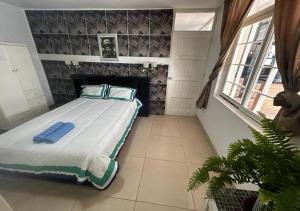 a bedroom with a bed with a stone wall at Playa Arica Backpackers in Arica