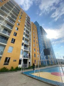 a large building with a basketball court in front of it at Apto Boho in Cartagena de Indias