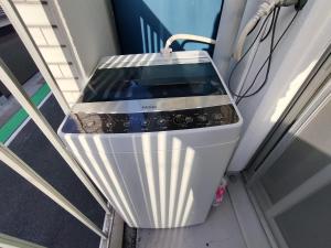 a washing machine sitting on top of a stairs at avanti house大橋A3 in Shiobaru +18 photos