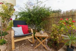 a chair and a table in a garden at Chrysoula's Vintage Home in Chios