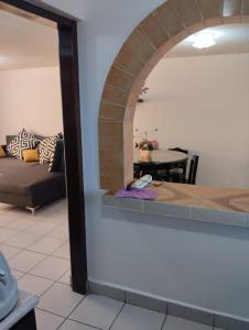a living room with a couch and an archway at CASA HUAXYACAC in Oaxaca City