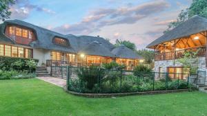 a large house with a gambrel roof at Malinga GuestHouse in Sandton