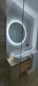 a bathroom with a sink and a mirror at SIA Studio in Oradea +32 photos