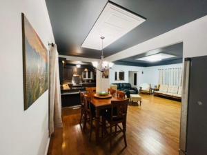 a living room with a dining table and a kitchen at Chalet Pakingan Gaspesie Cap-Chat in Cap-Chat