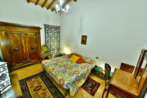 a bedroom with a bed in a room with rugs at Agriturismo Corvaia in Radicofani