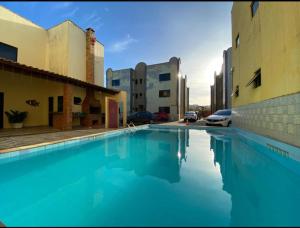 a large pool of blue water next to buildings at Flat Crystal Park Porto das Dunas- Cristal park in Aquiraz