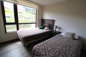Ένα ή περισσότερα κρεβάτια σε δωμάτιο στο TuArriendoCL-MPHB204 Depto 2D2B en Puerto Varas 4 PAX sin vista al lago