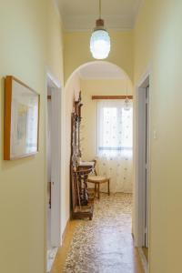 a hallway with a room with a table and a window at Chrysoula's Vintage Home in Chios
