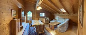 a living room with a couch and a table in a cabin at Ferienwohnung Volgger in Mils bei Hall