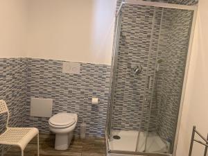 a bathroom with a toilet and a glass shower at BorgoMarino's Room in Cefalù