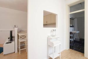 a room with a kitchen and a living room at Exclusive 2-room souterrain apartment in Nuremberg