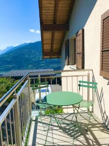 a table and chairs on a balcony with a view at Chez Marilyne in Savièse