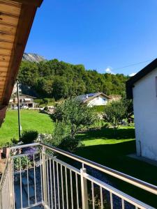 a balcony of a house with a view of a yard at Chez Marilyne in Savièse