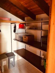 a kitchen with some shelves in a room at Chez Marilyne in Savièse