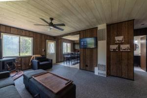 a living room with a couch and a ceiling fan at Mud Creek Cottage in Cheboygan