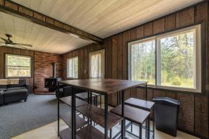 a dining room with a table and chairs in a room at Mud Creek Cottage in Cheboygan