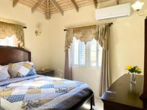 a bedroom with a bed and a table and a window at Casa Amarilla in Woods