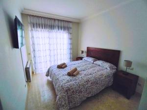 a bedroom with a bed with two pillows on it at Apartamento 3 dormitorios Roda Golf in Murcia