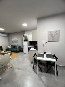 a living room with a table and a kitchen at Othonos 10 str. apartment. in Tríkala +8 photos