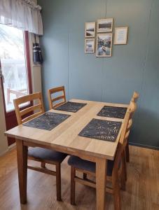 een eettafel met 2 stoelen en een houten tafel bij Storgalten gjestehus in Nord-Lenangen