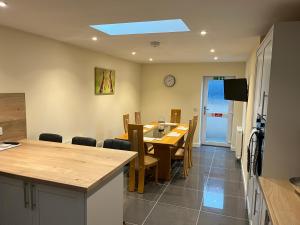 a kitchen and dining room with a table and chairs at Beldorny in Kingston