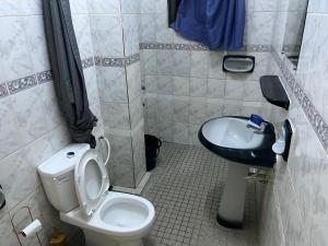 a bathroom with a toilet and a sink at Luxious Cosy Apart 2 Bedroom Cotonou Centre in Cotonou