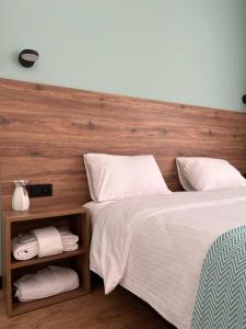 a bedroom with a large bed with a wooden headboard at Hotel Grand View in Stepantsminda