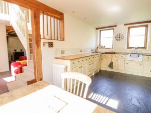 a kitchen with a sink and a counter top at Pandy Farmhouse - Panoramic mountain views within Snowdonia's National Park - 4x4 recommended in Dolgellau