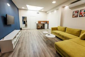 a living room with a couch and a tv at B2 Delux Studio Saffron in Plovdiv