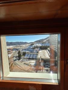 a window with a view of a city at Brown bear home in Roccaraso