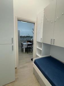 a bedroom with a bed and a dining room with a table at Appartamento Cosy Centro Storico in Barletta
