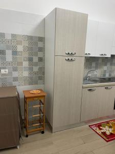 a kitchen with a sink and a refrigerator at Appartamento Cosy Centro Storico in Barletta