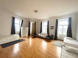 a living room with a bed and a couch at Prater City Hostel in Vienna