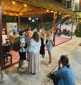a group of people standing in front of a crowd at Sabai Sabai Backpackers Hostel in Luang Prabang