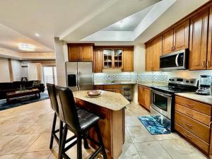 a large kitchen with wooden cabinets and a counter top at Luxurious Retreat in Port-of-Spain