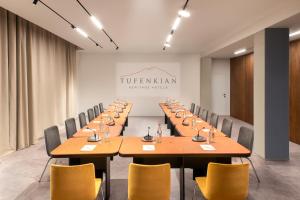 una sala de conferencias con una mesa larga y sillas en Tufenkian Historic Yerevan Hotel en Ereván