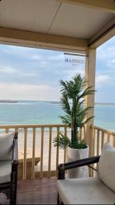 a balcony with a view of the beach at sea breeze RAK in Ras al Khaimah