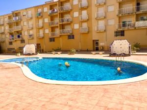 a swimming pool in front of a building at Apartamento en el Edificio Barlovento, situado en el centro de Alcossebre, a 150m del mar in Alcossebre