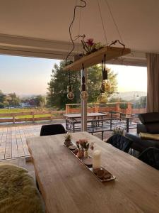 a wooden table with a tray with a candle on it at Ferienhaus Mountain View Six50 mit Sauna und Kamin in St. Andreasberg in Sankt Andreasberg