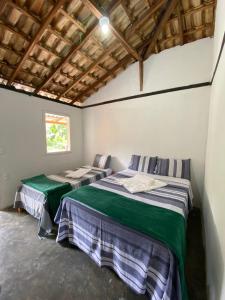 Giường trong phòng chung tại Hospedagem Vilella da Serra