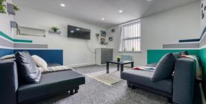 a living room with two couches and a tv at Modern Flat near City Centre - 8 Guests, 2 Baths in Cardiff