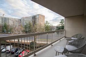 a balcony with chairs and a view of a parking lot at Sensational Condominium @Crystal City in Arlington