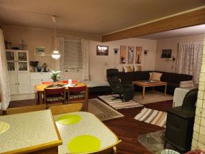 a living room with a couch and a table at Tromtind Lodge in Tromsø