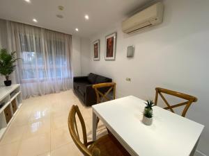 a living room with a table and a couch at Apartamento Sol y Agua en Fuengirola, Los Boliches in Fuengirola